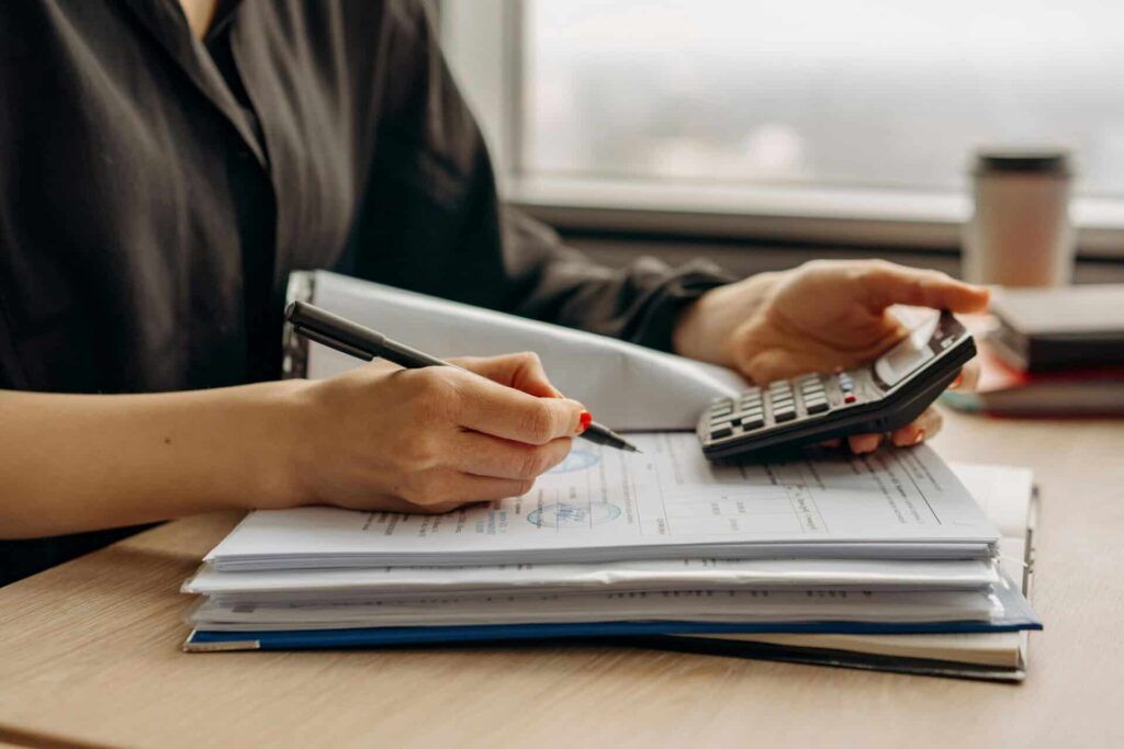 investing for beginners 2025 - person writing financial goals