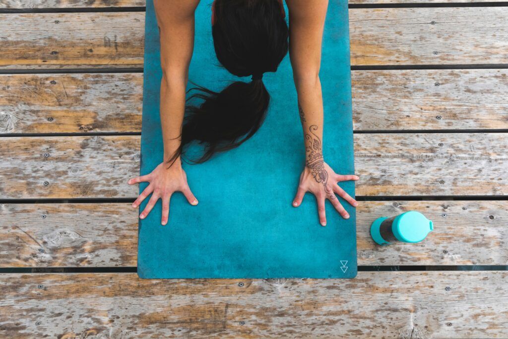 yoga mat flatlay with water bottle