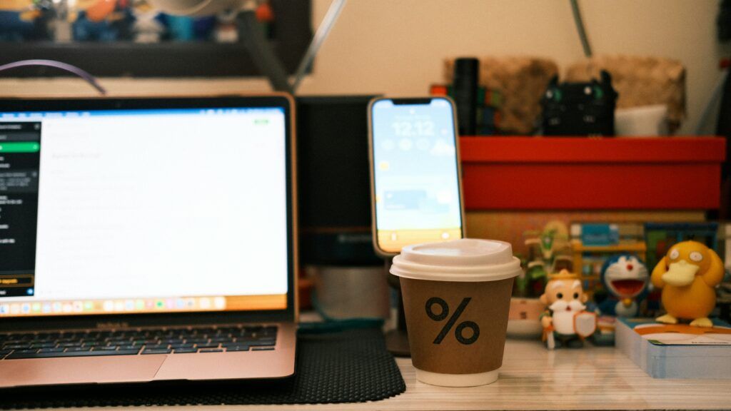 workspace setup with coffee and tablet