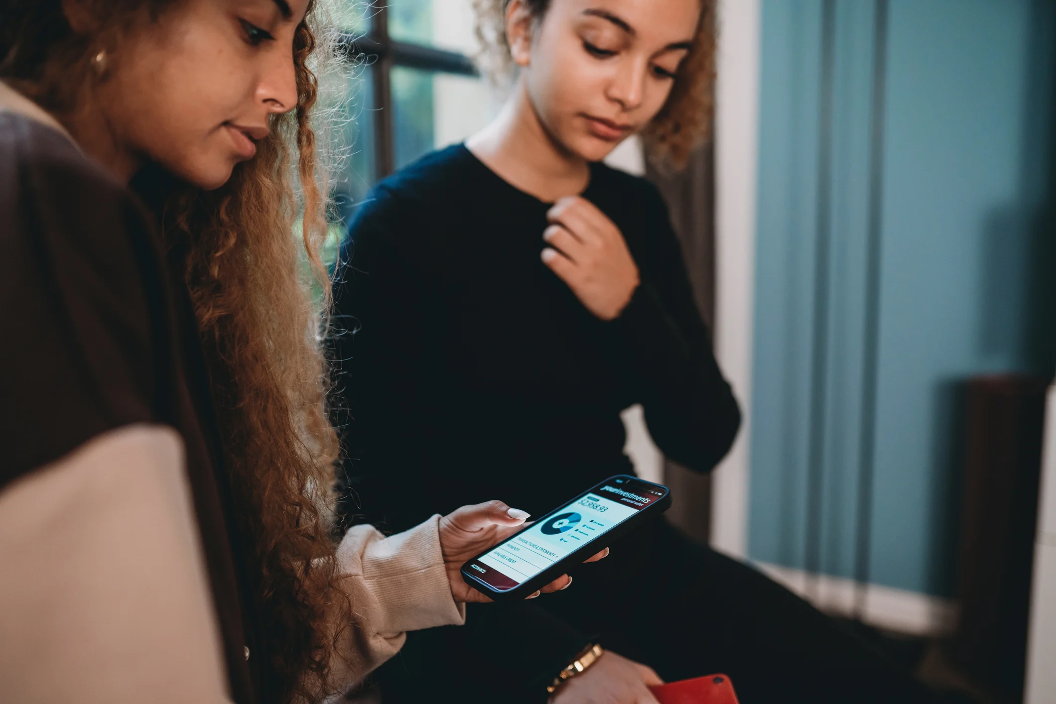 young person using investment app on phone