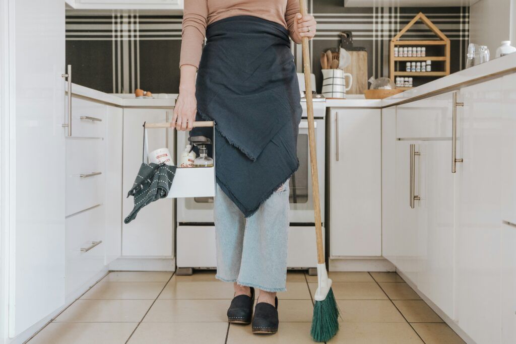 person cleaning kitchen