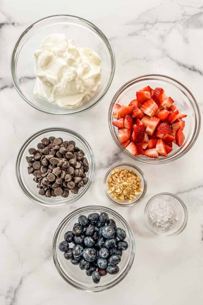 top-down flatlay of ingredients (berries, yogurt, chocolate)