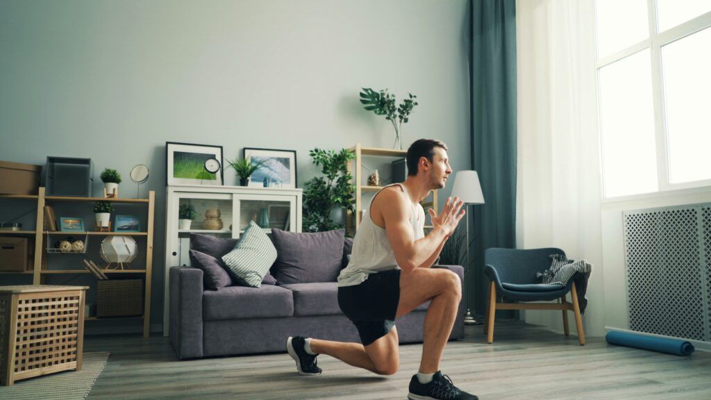person doing squats in living room
