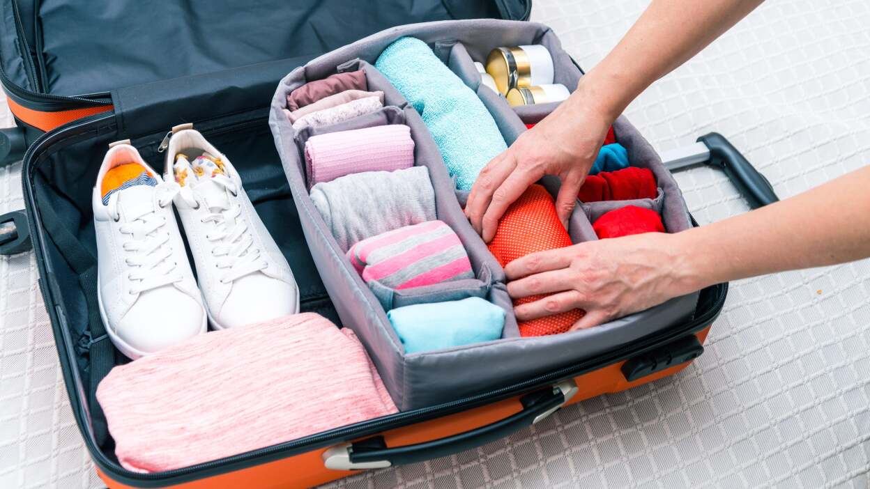 suitcase with neatly rolled clothes