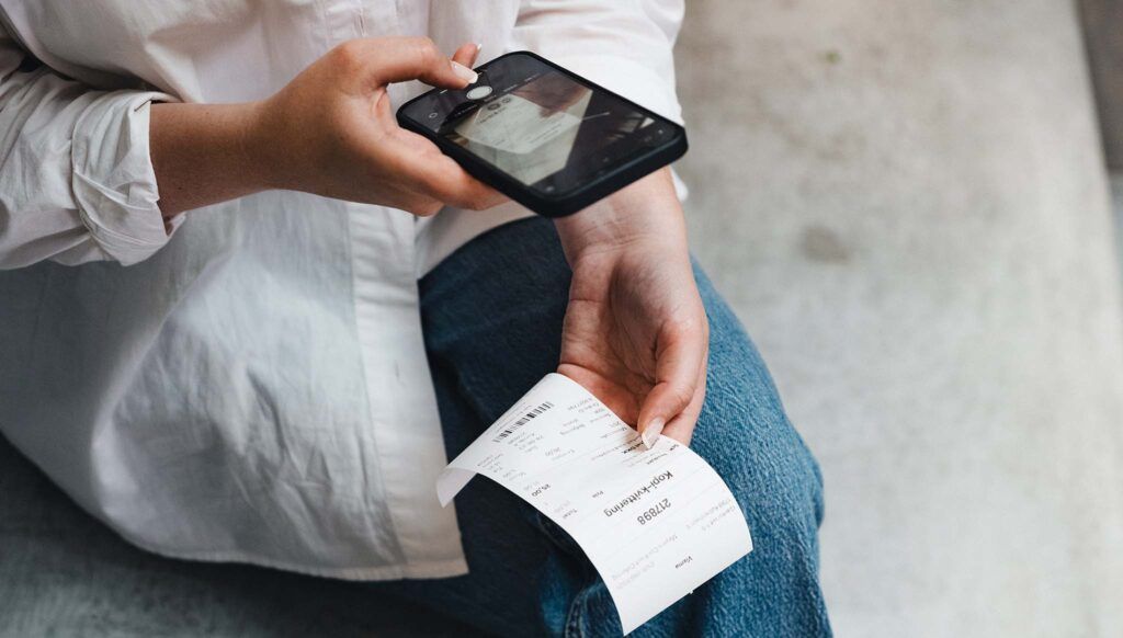 person scanning grocery receipt
