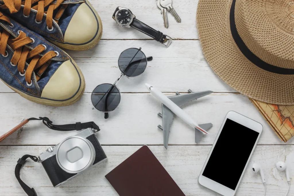 travel essentials (passport, phone, sunglasses)